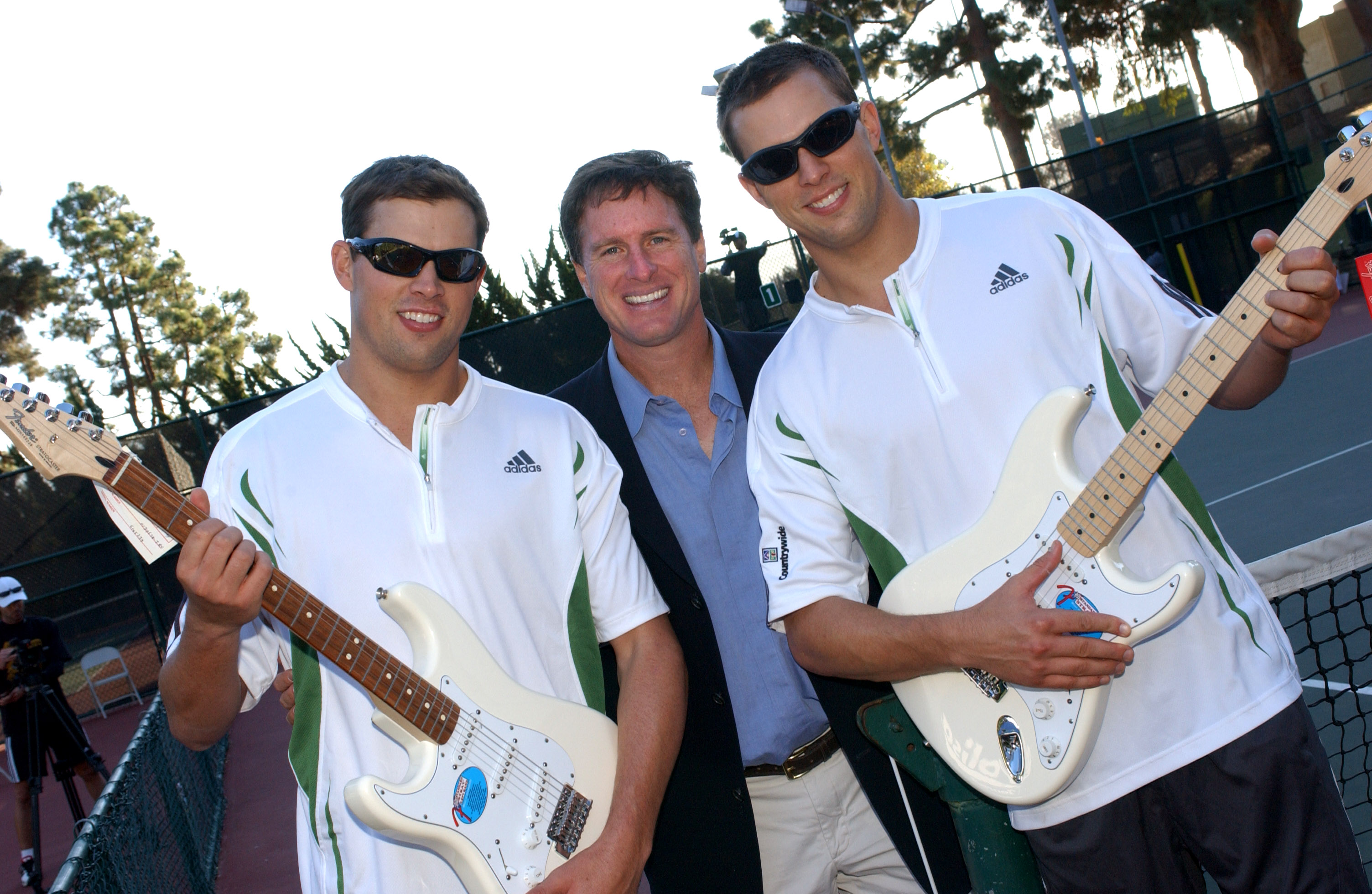 Steve Bellamy (center) presented brothers Mike and Bob Bryan with new Stratocaster electric guitars at the Palisades Tennis Center's 10th anniversary event in 2006.